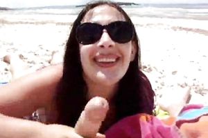 Slender brunette hair babe gives me a oral-stimulation at the beach