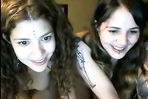 Two lubricious coeds with tattoos are fooling around in front of a webcam