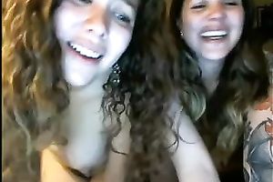 Two lubricious coeds with tattoos are fooling around in front of a webcam