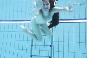 Cute and playful dark brown Russian skank in the pool