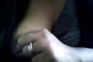 Bored serious looking web camera fatso rubs her puffy teats and milk cans