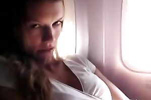 Lovely and sexually excited blond sweetheart on the plane flashing and masturbating