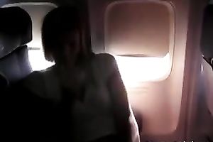 Lovely and sexually excited blond sweetheart on the plane flashing and masturbating