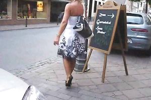Torrid golden-haired wife walks on the street teasing with her nylons