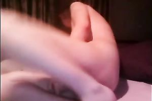 Pale skinned gal with big meatballs shoving her twat with sex toy