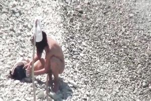 Cute and slim white brunette hair hotwife on the pebbly beach