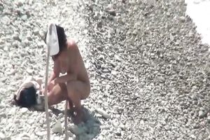 Cute and slim white brunette hair hotwife on the pebbly beach