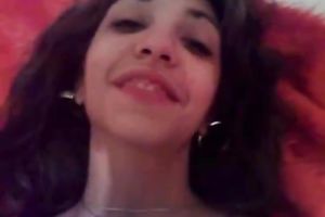 Busty dark brown in straps and nylons is posing for a webcam