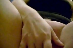 Horny and perverted slut with black hair fingering her love button