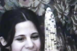 Svelte brunette hair beauty masturbates her curly snatch with corn cob