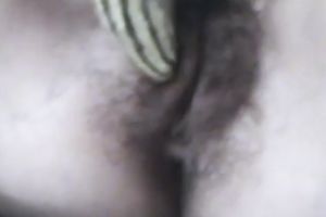 Svelte brunette hair beauty masturbates her curly snatch with corn cob