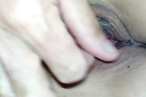 My charming gf lies in couch and I play with her bald pink pussy