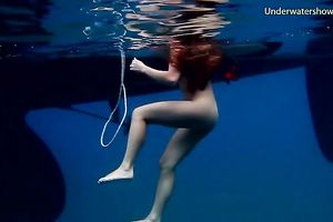 Slender and juvenile redhead harlot in the unfathomable blue sea