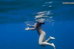 Slender and juvenile redhead harlot in the unfathomable blue sea