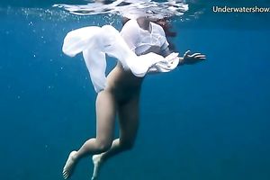 Slender and juvenile redhead harlot in the unfathomable blue sea