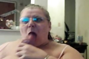 Horny and excited older fattie engulfing a fake penis on web camera
