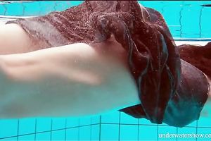 Mesmerizing and youthful dark brown beauty underwater on livecam