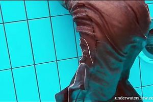Mesmerizing and youthful dark brown beauty underwater on livecam