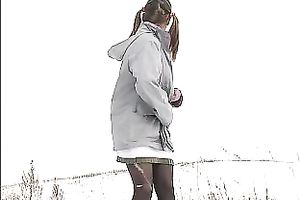 Cute youthful white honey pissing outside in a snowy day