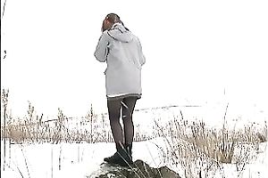 Cute youthful white honey pissing outside in a snowy day