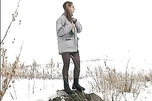 Cute youthful white honey pissing outside in a snowy day