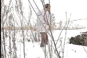 Cute youthful white honey pissing outside in a snowy day