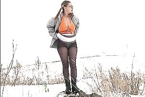 Cute youthful white honey pissing outside in a snowy day