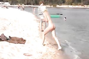 Two breathtaking white sweethearts on the beach posing stripped in public