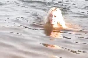 Two breathtaking white sweethearts on the beach posing stripped in public