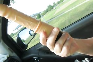 My perverted girlfriend masturbating with large sex toy on a front seat in a car