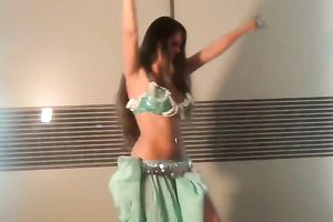 Well shaped girlie dancing seductively in eastern costume