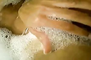 Seductive brunette hair hottie is washing heк hairless love tunnel in a washroom tub