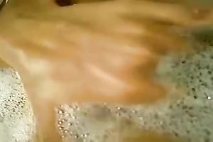 Seductive brunette hair hottie is washing heк hairless love tunnel in a washroom tub