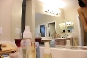 Skinny college sweetheart puts on makeup all bare in front of the mirror