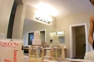 Skinny college sweetheart puts on makeup all bare in front of the mirror