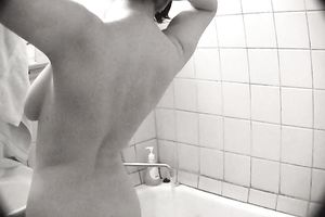 Dark haired large bottomed non-professional cutie takes a shower on camera