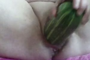 Wife uses cucumber to permeate her moist itchy fanny on ottoman