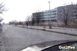 Amateur wench doesn't mind to pee in the street in urinate fetish movie scene