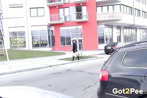 Amateur wench doesn't mind to pee in the street in urinate fetish movie scene