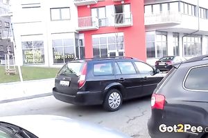 Amateur wench doesn't mind to pee in the street in urinate fetish movie scene