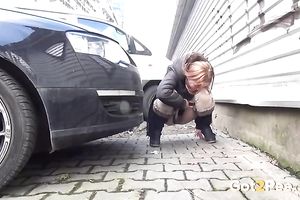 Amateur wench doesn't mind to pee in the street in urinate fetish movie scene