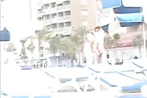 Sexy babe on the beach lets her boyfriend rub her muff