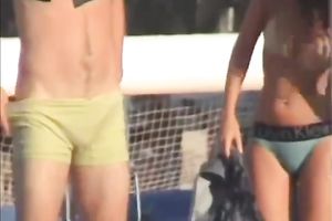 Sexy babe on the beach lets her boyfriend rub her muff