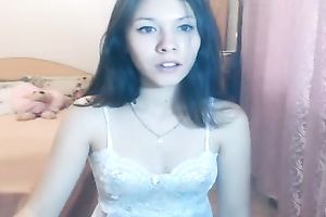 Lovely teen with jet dark hair is having a great time stripping on cam