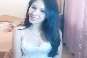 Lovely teen with jet dark hair is having a great time stripping on cam