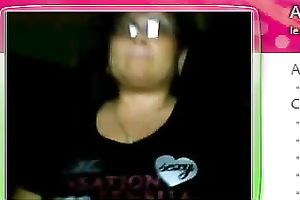 Fat granny sits in front of the web camera and rubs her fanny