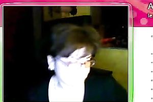 Fat granny sits in front of the web camera and rubs her fanny