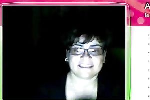 Fat granny sits in front of the web camera and rubs her fanny