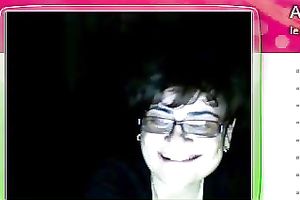 Fat granny sits in front of the web camera and rubs her fanny