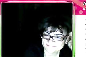 Fat granny sits in front of the web camera and rubs her fanny